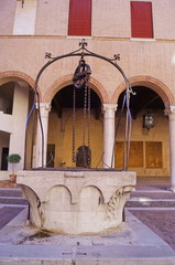 Well in the courtyard of the Este castle, Ferrara, Italy