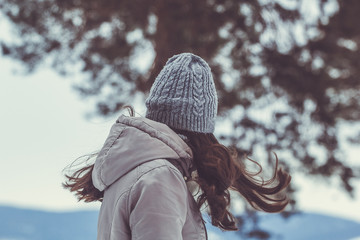 happy girl walking in winter forest