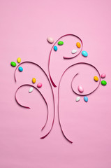 Easter Concept, Cookie Cutters and Chocolate Eggs on Pink Background