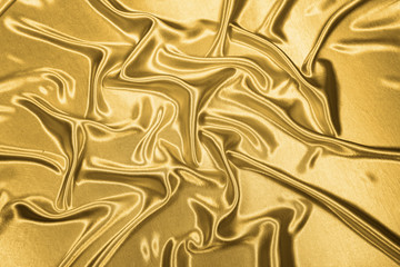 Gold luxury satin fabric texture for background and art design
