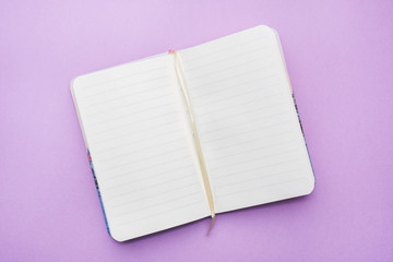 Top view of the opened notebook with blank paper for copy space.
