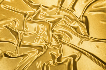Gold luxury satin fabric texture for background and art design