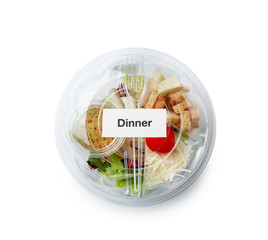 Container with delicious food for delivery on white background