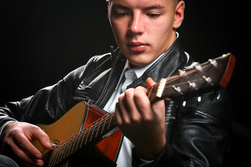 Young men playing the guitar