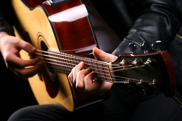 Young men playing the guitar