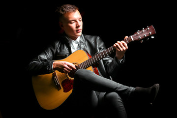 Young men playing the guitar