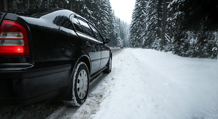 Obraz na płótnie Canvas Car on road at snowy winter resort