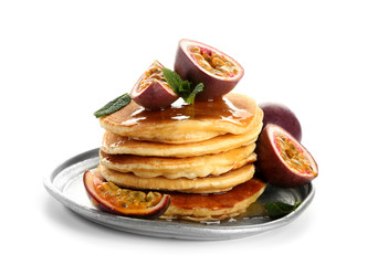 Tasty pancakes with passion fruit on white background
