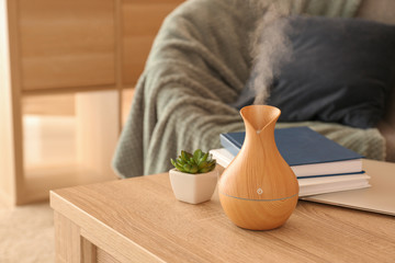 Aroma oil diffuser on table in room