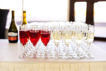 a row of glasses filled with champagne are lined up ready to be served