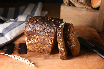 Delicious sliced bread on wooden board