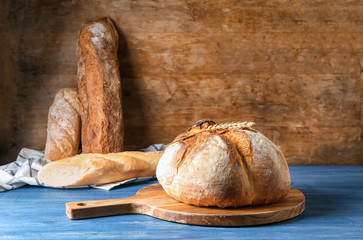 Tasty fresh bread on wooden table