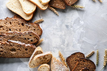 Assortment of tasty bread on grey background