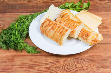 Whole and halves of cheese-stuffed bread sticks, different cheese