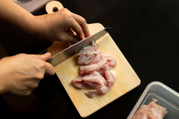 Chef cutting meat.