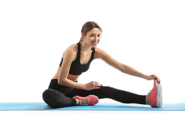 Sporty young woman training against white background