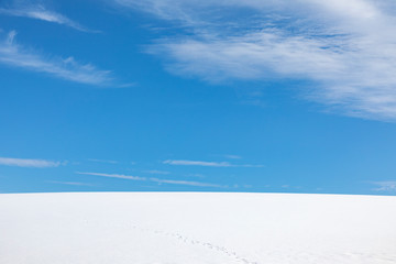 Fototapeta na wymiar blue sky over white snowfield
