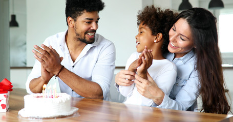 Happy family celebrating birthday of their child