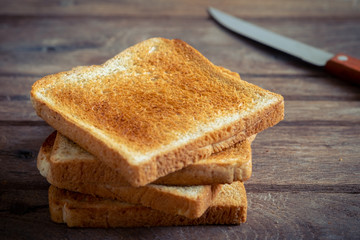 Stack of sliced toast on old wooden table