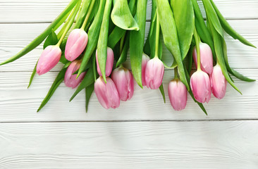 Bouquet of beautiful tulips on white wooden background
