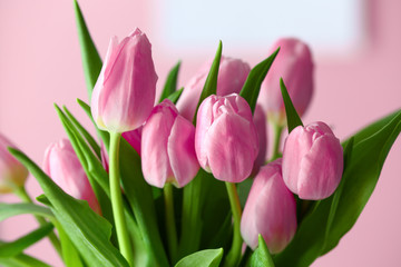 Bouquet of beautiful tulips on color background