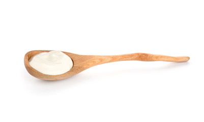 Spoon with tasty yogurt on white background
