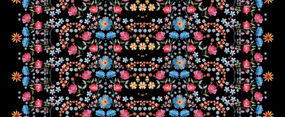 Embroidery seamless pattern. Beautiful vertical line with colorful summer flowers on black background. Embroidered print. Fashion design.