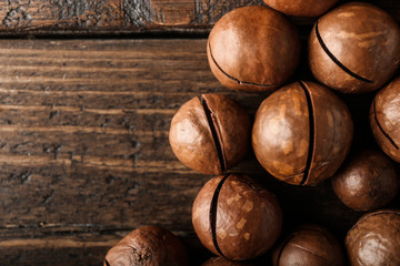 Tasty macadamia nuts on wooden table
