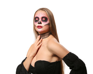 Young woman with painted skull on her face for Mexico's Day of the Dead against white background
