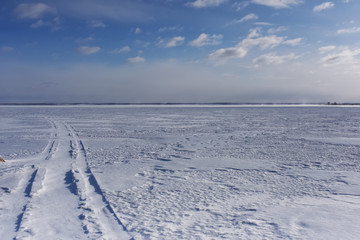 Fototapeta na wymiar road to the horizon on the ice-covered lake