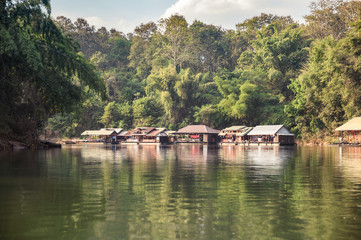 Fototapeta na wymiar Wooden raft building on river kwai in tropical rainforest at Kanchanaburi