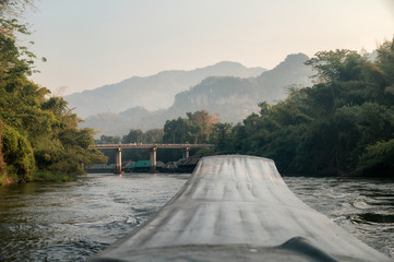 Sailing long-tail boat sightseeing rainforest in river kwai