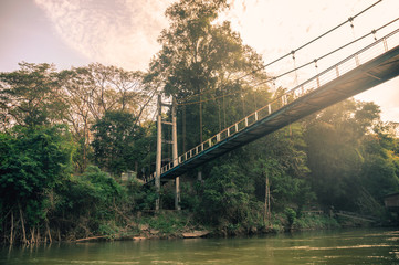 Bridge cross on river kwai in tropical rainforest