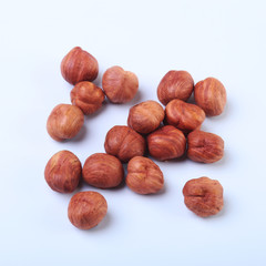 Hazelnuts isolated on white background. Selective focus.