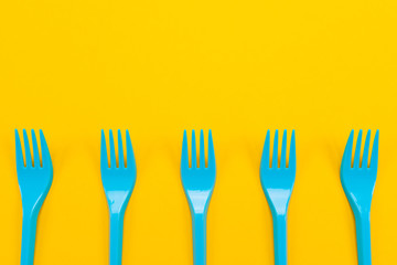 Colorful set of vibrant forks and knife isolated on black