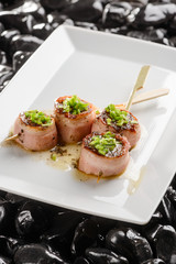 Salmon skewers on white plate