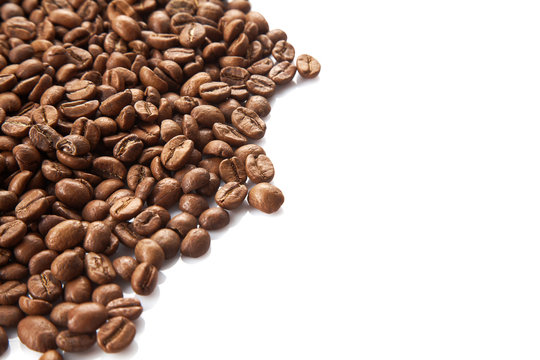 Close up view on Heap of coffee beans isolated on white background. Useful image for design with copy space