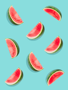 Watermelon pattern. Slices of watermelon on a plain surface painted in bright blue