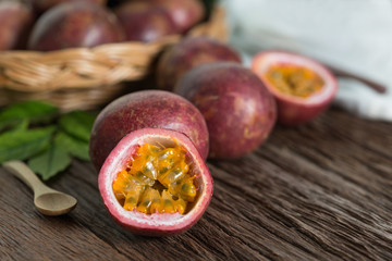 Half of  passion fruit and organic passionfruit on wood basket, wooden background.