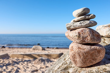 Fototapeta na wymiar Stack of stones on a beach, balance and harmony concept, selective focus.