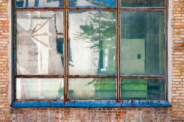 Old metallic window surrounded by red bricks in a soviet building of  Kiev, Ukraine