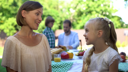 Fototapeta premium Mom talking to daughter while dad having conversation with son, trust relations