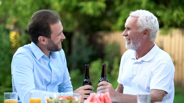 Successful Adult Son Drinking Beer With Dad, Thanking Father For Upbringing