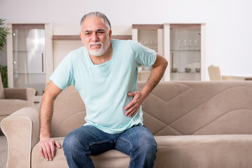 Fototapeta premium White bearded old man suffering at home 