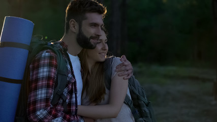 Tourist lovers camping in forest, watching wonderful view and hugging, hiking