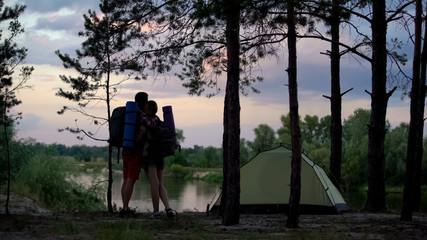 Tourists looking at beautiful scape and hugging, romantic trip, common interests