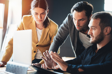 Business teamwork situation. Group of three people discussing daily plans in the office