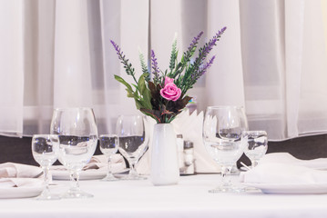 glasses on the table and a flower on a white background