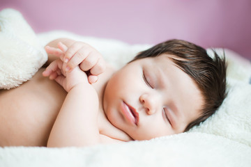 baby, newborn baby cute blue-eyed, dark hair, baby 2 months without clothes sleeps