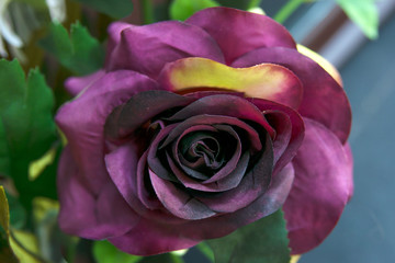 Fototapeta na wymiar Artificial Purple Fake Flowers Rose Bouquet
